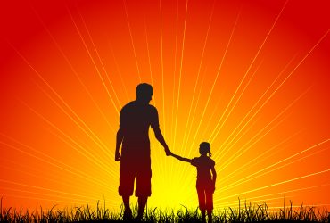 Silhouette of a father and his daughter walking